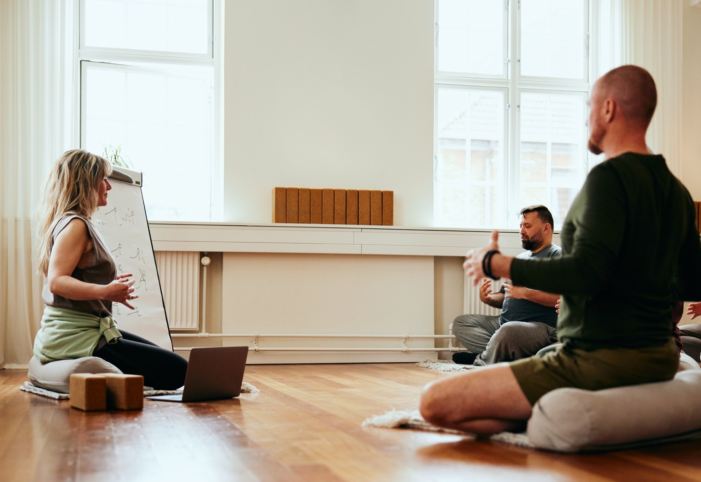 Yoga instructor teaching breathing exercises
